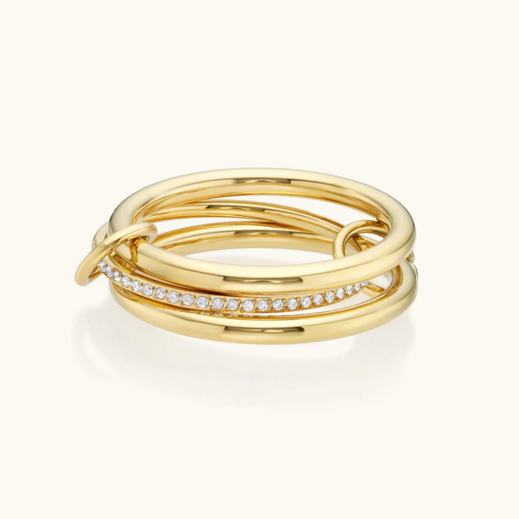 Three gold rings with embedded diamonds on a white background