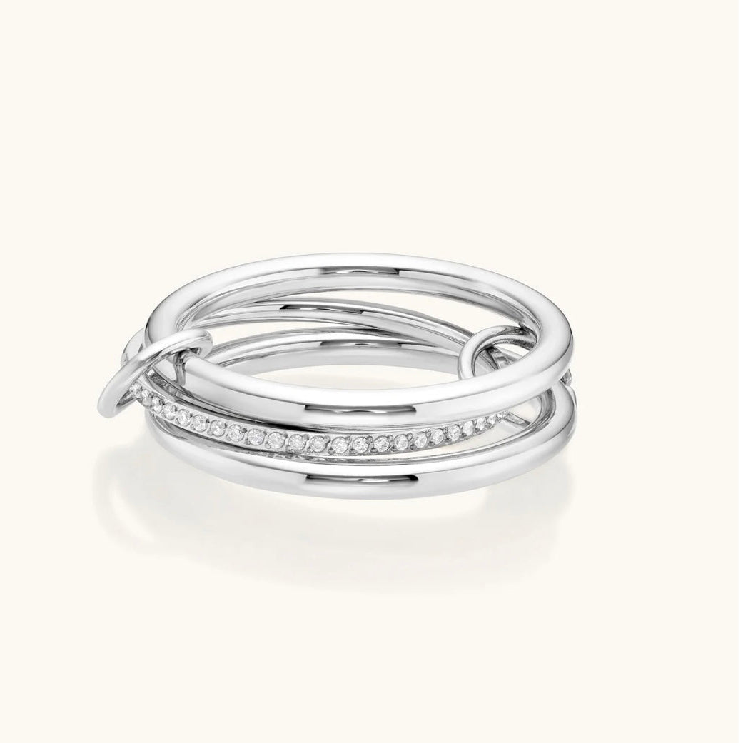 Set of three silver rings with diamond accents on a white background