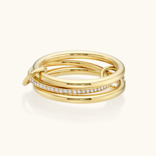 Three gold rings with embedded diamonds on a white background